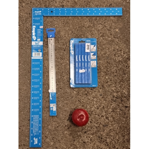 A collection of three Empire carpentry items, including a brand new framing square, a heavy duty stainless steel ruler and a ten piece pack of HB carpenters pencils. All new.