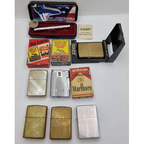 25 - A good collection with five Zippo lighters, which includes some vintage examples and a Bronson gas e... 