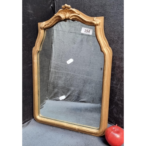 A lovely antique wall hanging mirror with a gilt frame.