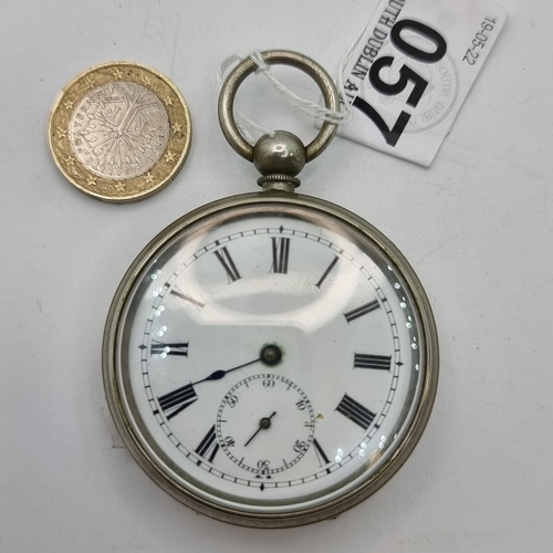 57 - A white enamelled roman numeral watch with subsidiary hand and stamped 