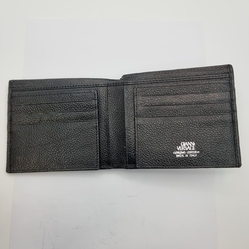55 - A black leather wallet with a mark stating 