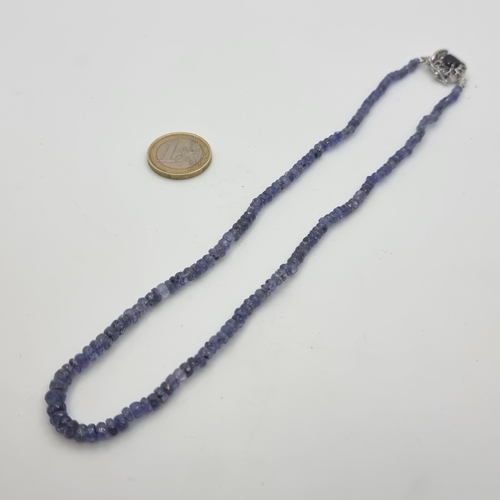 18 - An attractive graduated Sapphire stone necklace, with sterling silver Sapphire set clasp. Length of ... 
