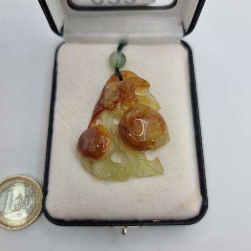 23 - A lovely monkey Jade pendant necklace, with floral leaf carvings. Dimensions: 5cm x 3.5cm. Length of... 