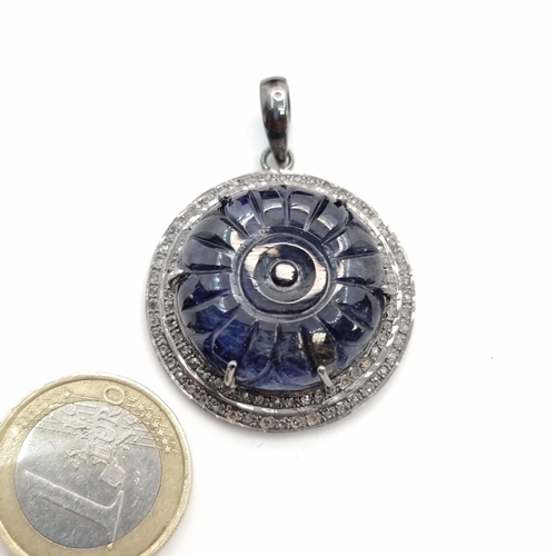 60 - Star Lot : A fabulous sapphire and diamond surround pendant. Length: 4.5 cms, width: 4.5 cms. Weight... 
