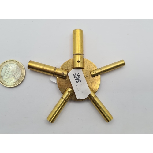 17 - A five stem brass universal clock key, with various sizes and definition to base. Very useful buy!