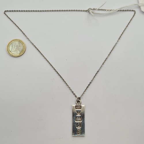 19 - A sterling silver ingot and chain. Hallmarked Birmingham, 1977 and markers mark state 