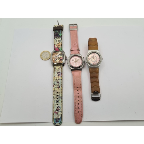 25 - A collection of items, including two Swatch watches with wristbands, a Walt Disney special collectio... 