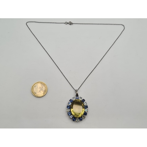 37 - A fantastic pendant necklace with large Citrine (36cts) central stone and a halo of blue kyanite and... 