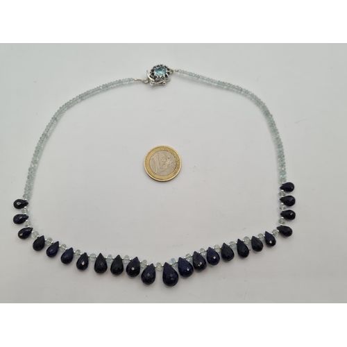 39 - An outstanding, graduated beaded necklace of 160cts aquamarine facet cut gemstones with Sapphire tea... 