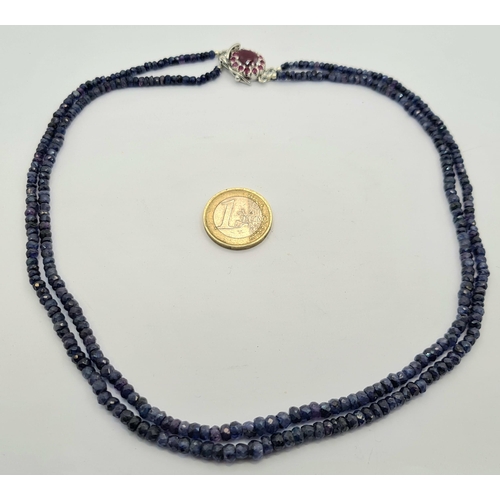 40 - A stunning natural blue Sapphire two strand necklace, with a detailed ruby set sterling silver clasp... 