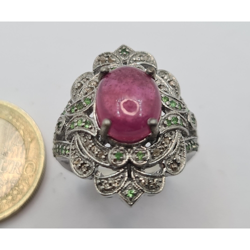 41 - A stunning  ring, with large 5.9cts cabochon ruby stone and ornate sterling silver surround set. Siz... 