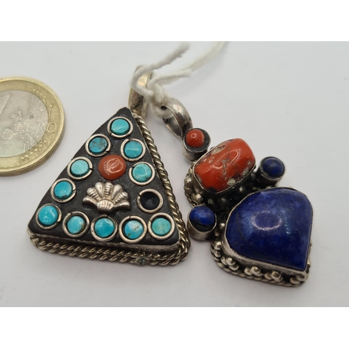 44 - Two Native American sterling silver pendants. The first is a nice triangular example with Turquoise ... 