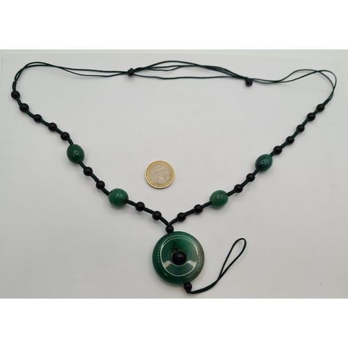 52 - A beautiful  example of a jade stone necklace with lovely accent detail. Length of necklace 60cm. St... 