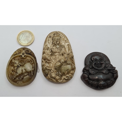 55 - A collection of three nicely carved stone pendants featuring Buddhas. Weights 27.1g, 21.15g and 57.3... 