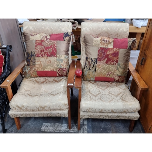 A lovely pair of vintage fireside chairs upholstered in champagne colour fabric. With four cushions nicely complimenting the textile. these are in lovely condition.