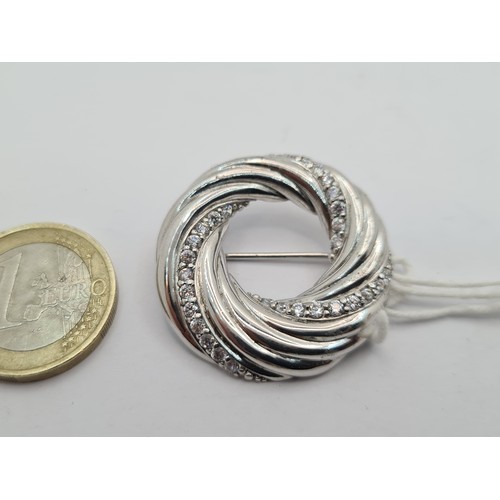 26 - A very attractive Sterling Silver gem stone swirl design brooch, with pin intact. Original price tag... 