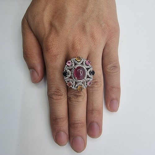 38 - An impressive ring with large cabochon ruby (7.35)  and ornate sterling silver surround set with pin... 