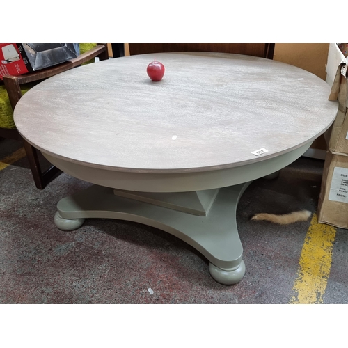 Star lot : A fabulous stylish heavy round coffee table with bun feet and and a warm grey finish. The main coffee table in the fabulous house in Wicklow. Cost €995 In VGC