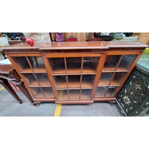 492 - A charming warm wood credenza with astro-glazed glass front and three lockable cabinets with two she... 