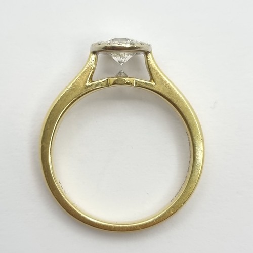 501 - Star Lot: An exquisite Halo classic Diamond ring, set in 18ct gold. This example is referred to as 