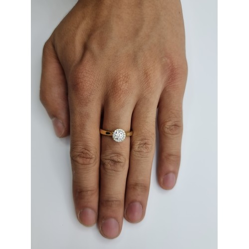 501 - Star Lot: An exquisite Halo classic Diamond ring, set in 18ct gold. This example is referred to as 