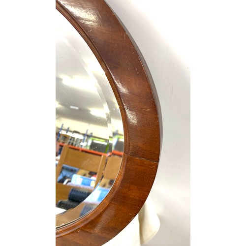50 - Mahogany framed oval mirror measures approx 30 inches by 18.5 inches