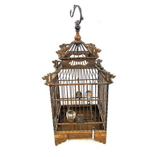 58 - Small oriental dragon themed bird cage measures approx 50cm tall
