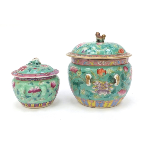577 - Oriental pot and cover hand painted with floral design with dog of Foo lid, together with a similar ... 
