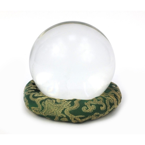 50 - Large fortune teller's crystal ball on an oriental Chinese dragon green cloth stand, the crystal bal... 