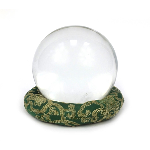 50 - Large fortune teller's crystal ball on an oriental Chinese dragon green cloth stand, the crystal bal... 