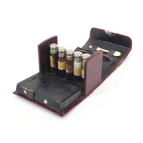 48 - French doctor's red leather travelling case housing a selection of glass bottles, spoon, penknife an... 