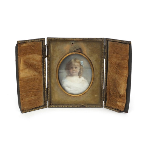 11 - Hand painted portrait miniature onto porcelain of a young girl, housed in a leather case, mounted, t... 