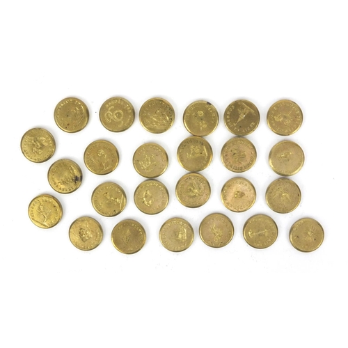 51 - Selection of intaglio moulded brass weights housed in a brass tube, the tube 5.5cm high