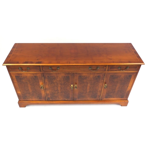 2029 - Inlaid yew sideboard fitted with three drawers above four cupboard doors raised on bracket feet, 80c... 