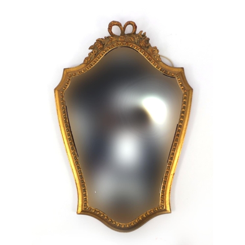 2032 - Gilt framed shield shaped mirror with ribbon crest, 48cm x 31cm