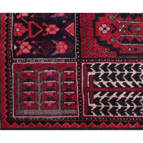 2035 - Rectangular Bakhtiari rug with an all over panelled design onto a red ground, 242cm x 156cm