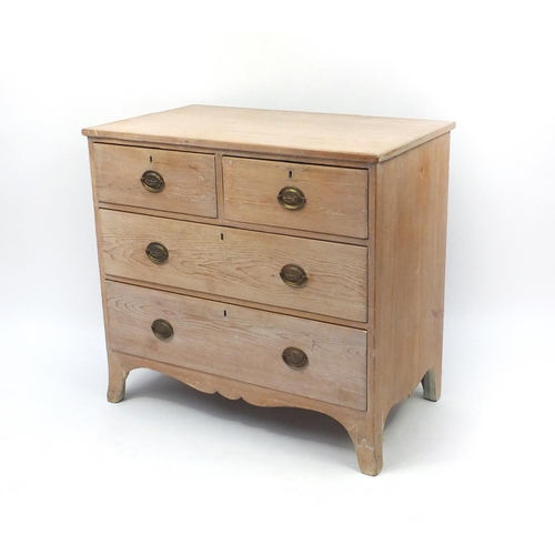 2024 - Bleached wooden four drawer chest with oval brass handles embossed with a classical reclining lady, ... 