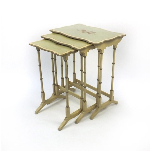 2053 - Nest of three green and cream painted occasional tables, the tops each hand decorated with musical i... 