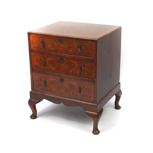 2052 - Walnut cross banded and feather banded three drawer chest on cabriole legs, 77cm high x 61cm wide x ... 
