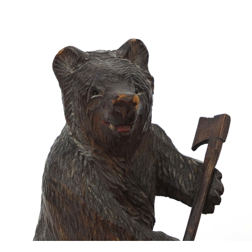 39 - Carved Black Forest smokers desk stand, mounted with a bear and barrel tobacco box, 17cm high