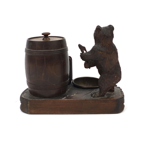 39 - Carved Black Forest smokers desk stand, mounted with a bear and barrel tobacco box, 17cm high