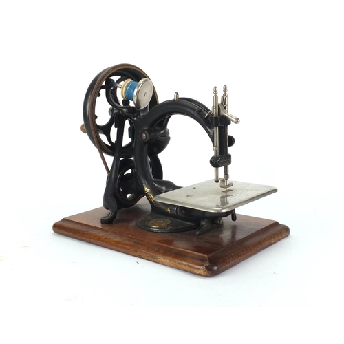52 - 19th century Wilcox and Gibbs mechanical sewing machine, with carrying case, 27cm high