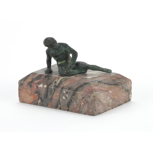 34 - Patinated bronze paperweight of a classical figure, raised on a rectangular marble base, 7cm high x ... 