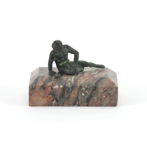 34 - Patinated bronze paperweight of a classical figure, raised on a rectangular marble base, 7cm high x ... 