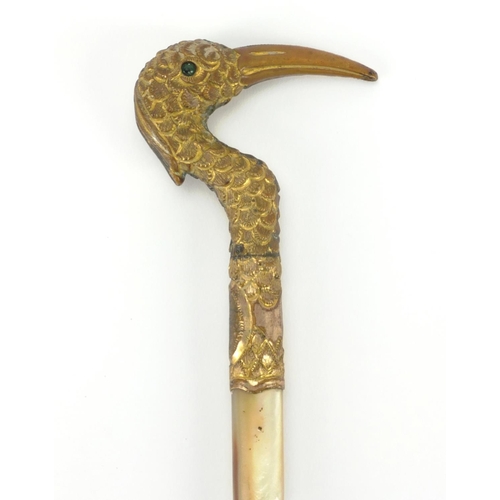 30 - Gilt metal Mother of Pearl and bamboo riding crop, the handle in the form of a bird, 39cm in length