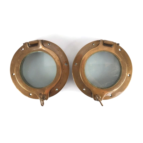 53 - Pair of shipping interest bronze and glass port holes, each 25cm in diameter