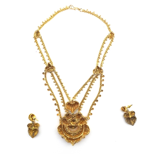404 - Indian gilt metal Filigree necklace and matching earrings, housed in a fitted box
