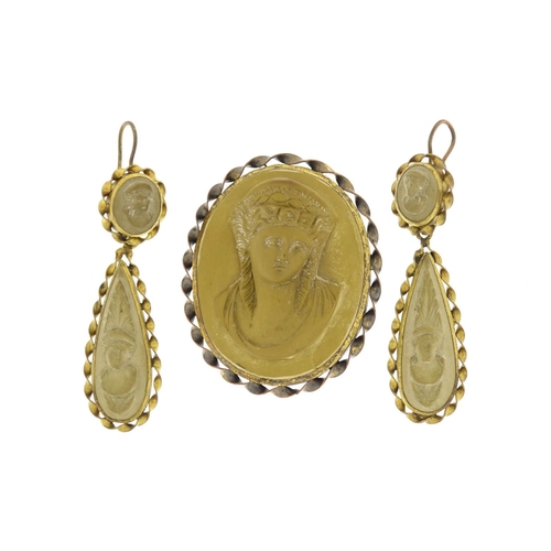 961 - Victorian lava cameo suite comprising a brooch and earrings carved with maiden heads, each with gilt... 
