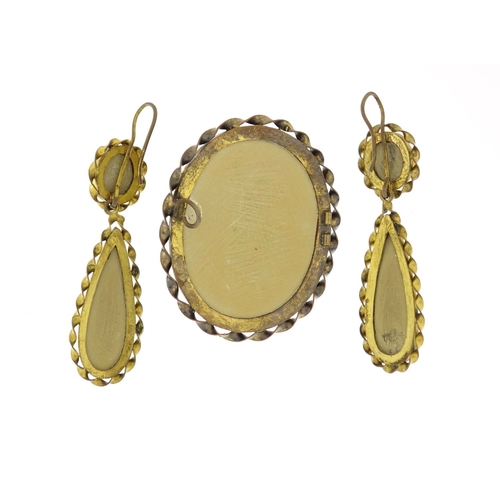 961 - Victorian lava cameo suite comprising a brooch and earrings carved with maiden heads, each with gilt... 