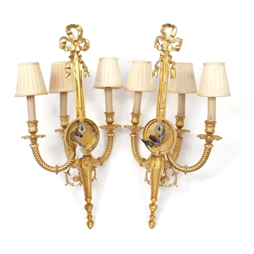 30 - Pair of Louis XVI style three branch brass wall sconces with shades, 67cm high